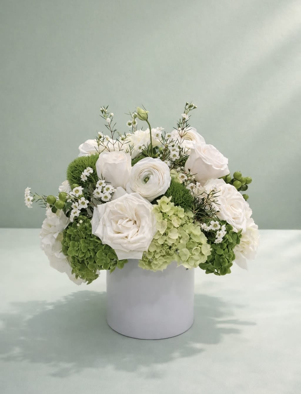 Emeralds and Pearls  - An exquisite symphony of premium ivory blooms and architectural greenery, masterfully arranged in refined whites and spring greens.