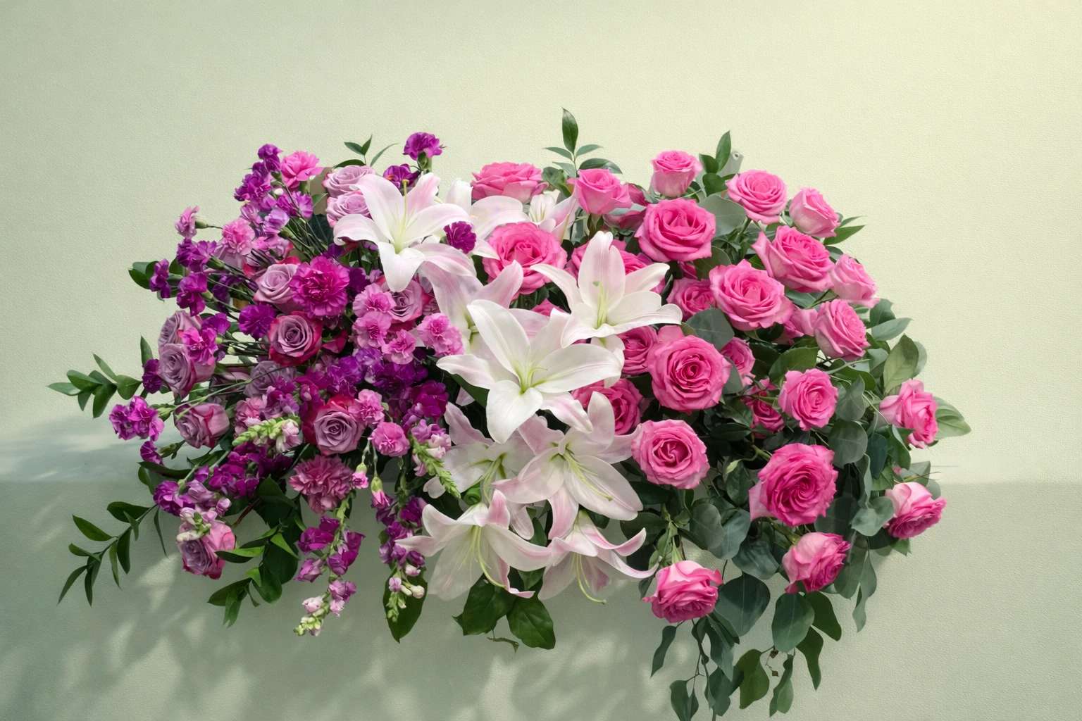 Pink roses and white lilies in a lush floral arrangement