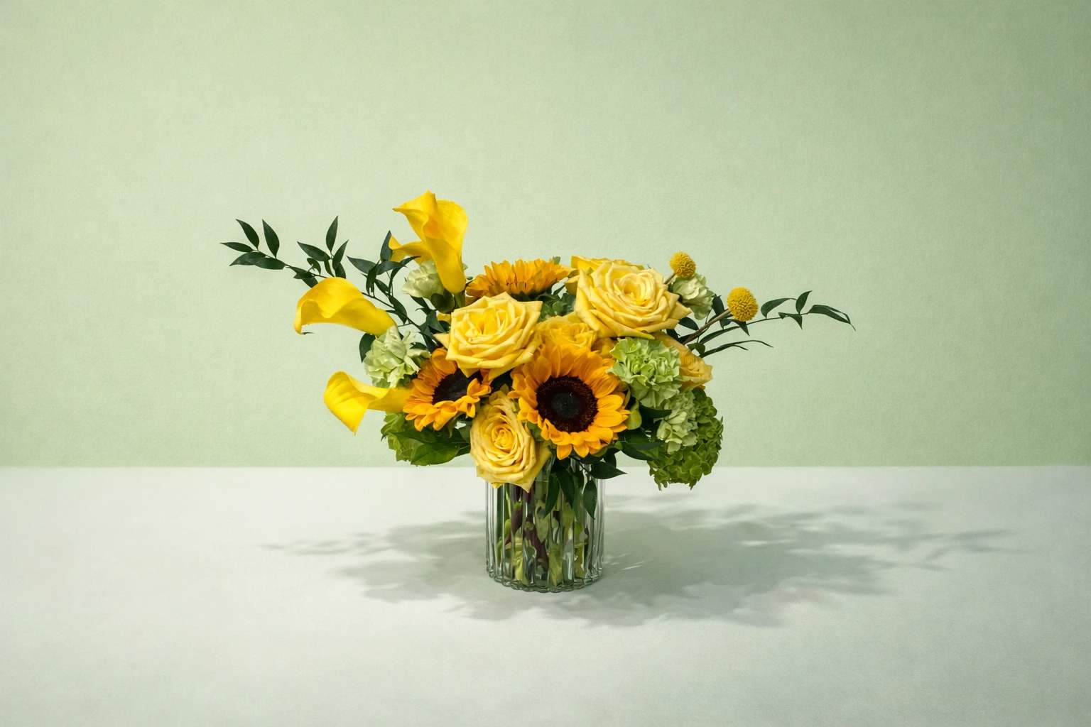 Yellow flowers arranged in a clear glass vase