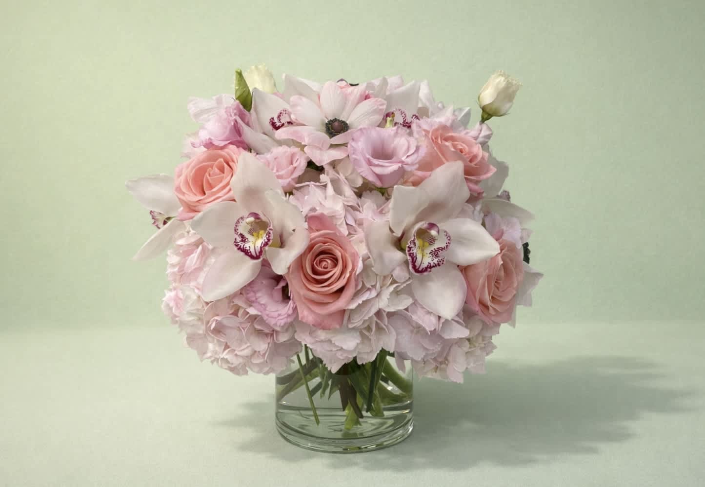 Pink and white floral bouquet in a clear glass vase