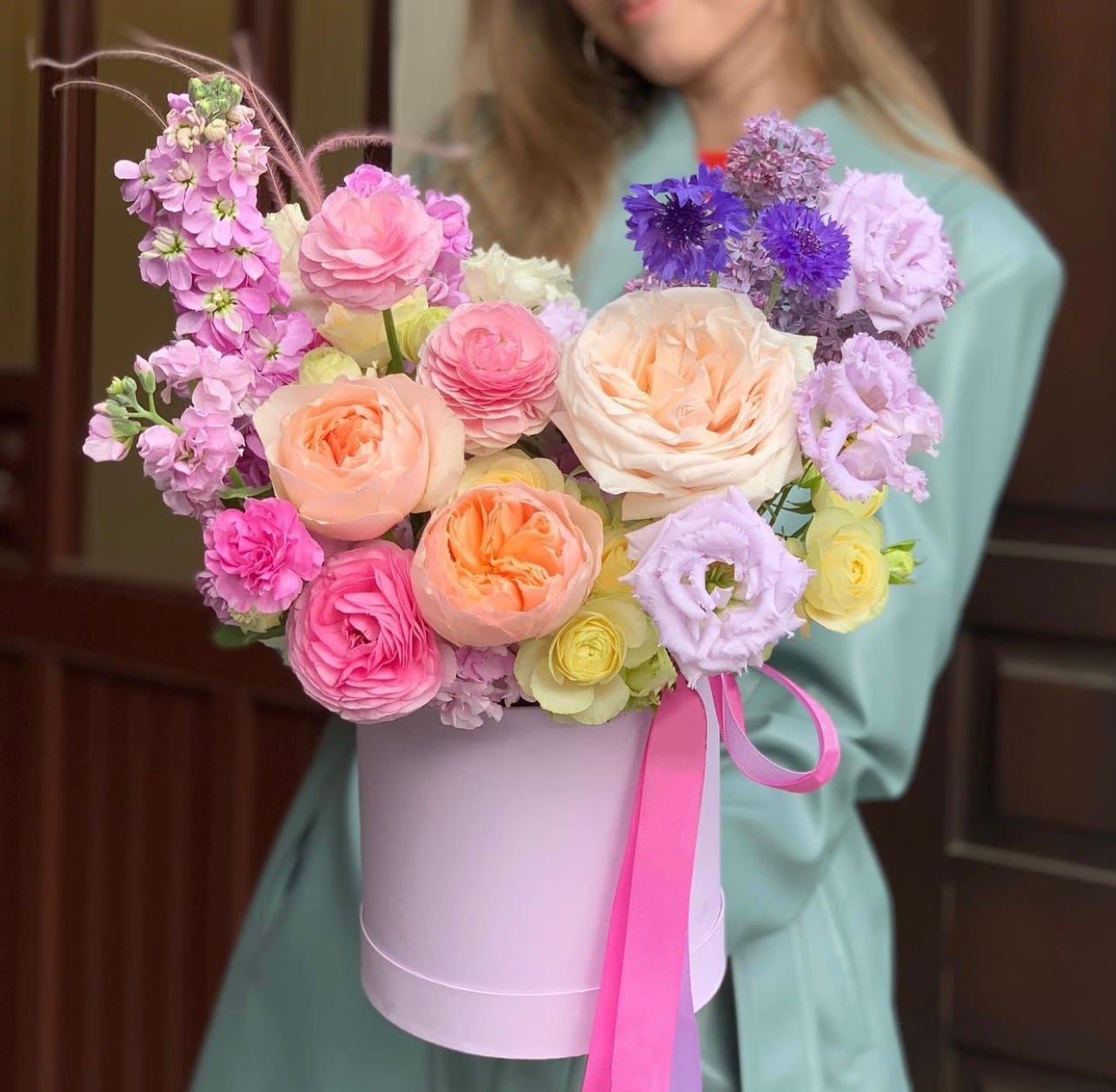 Pastel bouquet in a lavender hatbox with a pink ribbon