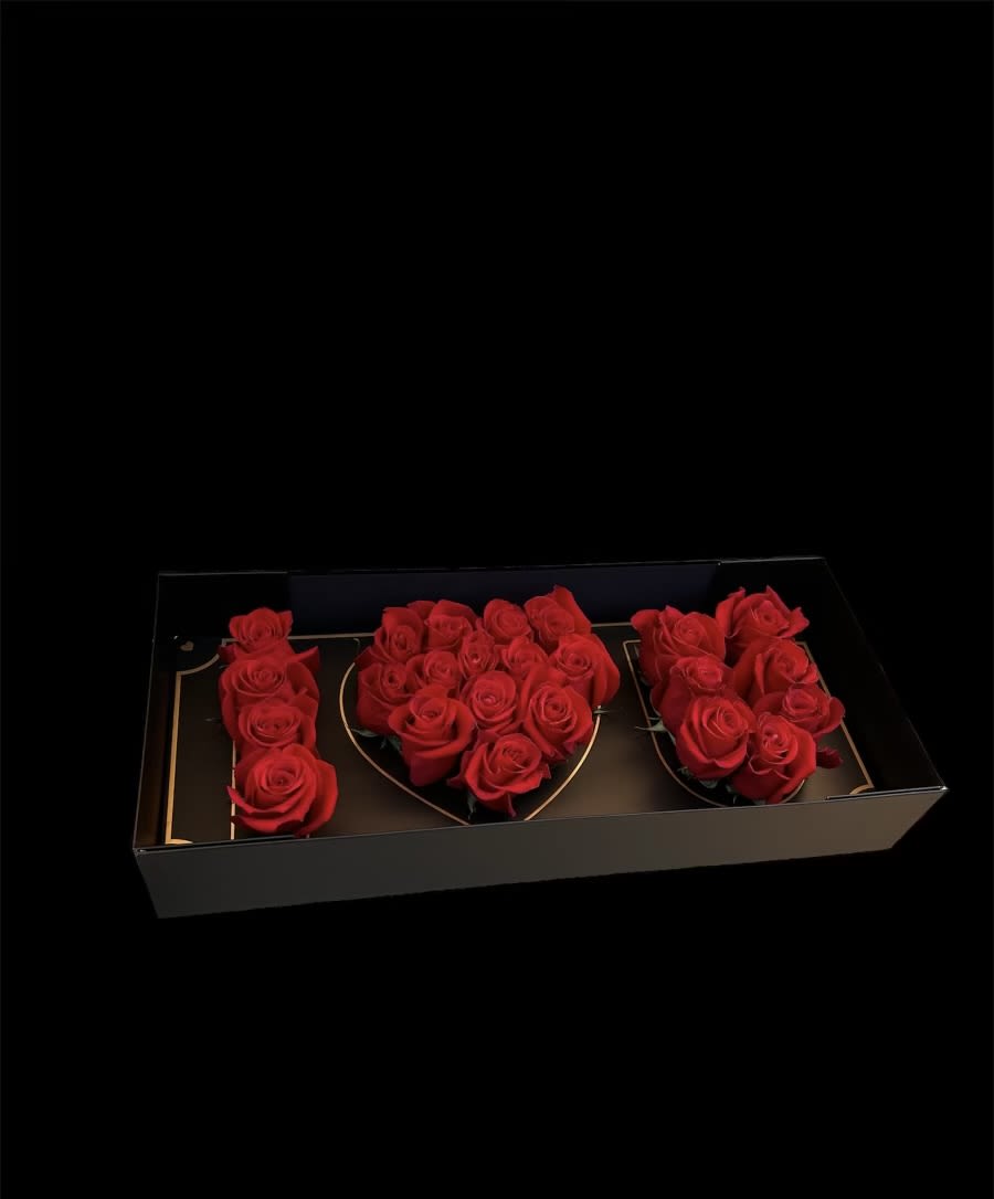 Red roses arranged in a black rectangular gift box
