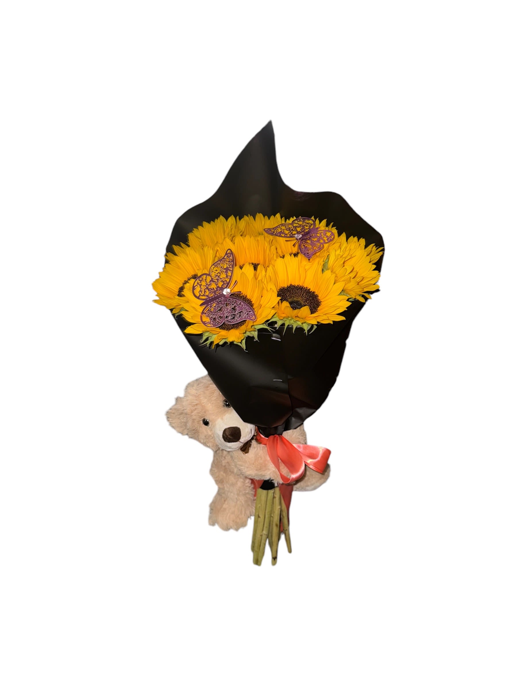 Sunflower bouquet wrapped in black paper with a teddy bear and ribbon