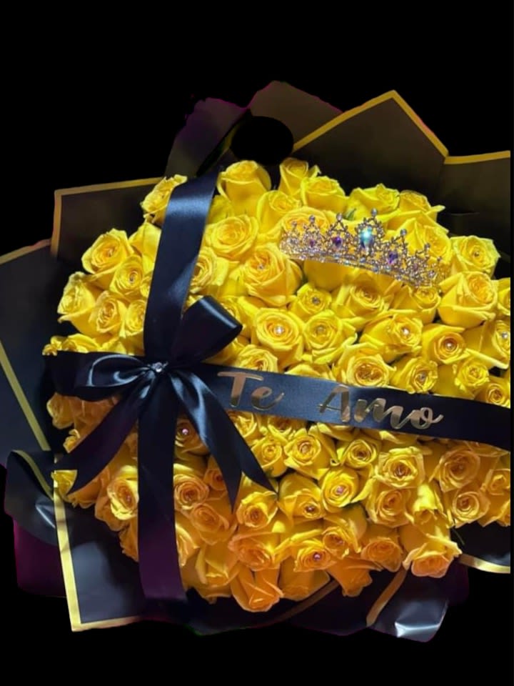 Bouquet of yellow roses with a black ribbon and crown topper