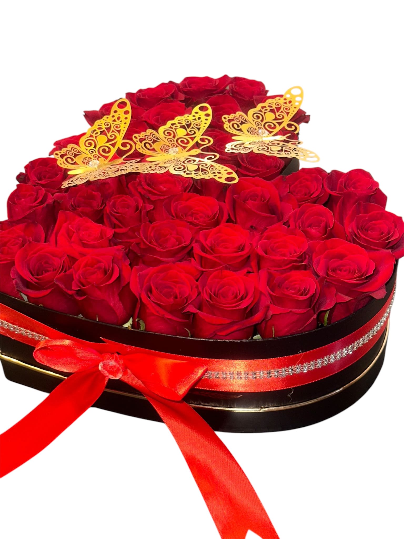Heart-shaped box of red roses with gold butterfly decorations and a red ribbon