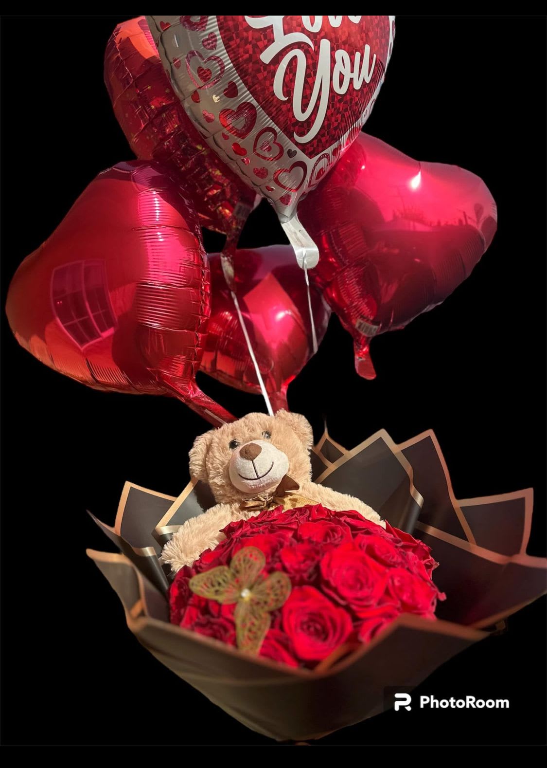 Red rose bouquet with a teddy bear and heart balloons
