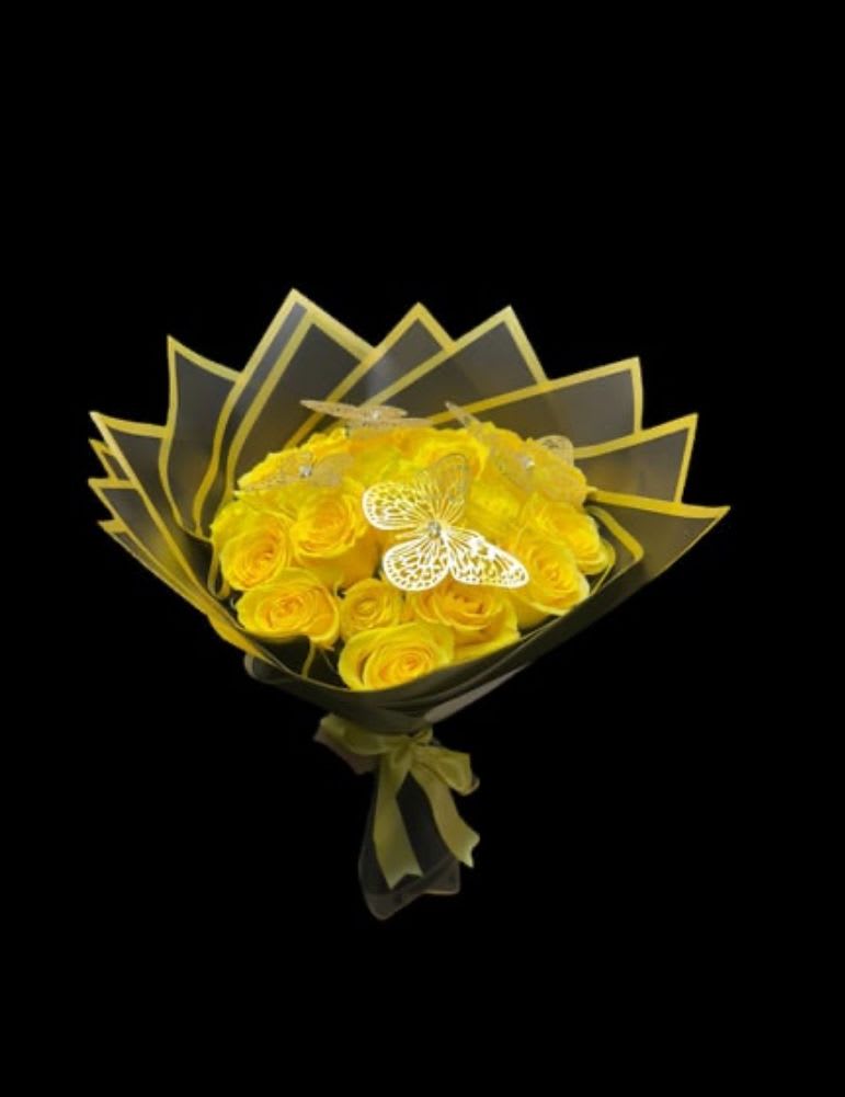 Yellow rose bouquet wrapped in dark paper with a ribbon