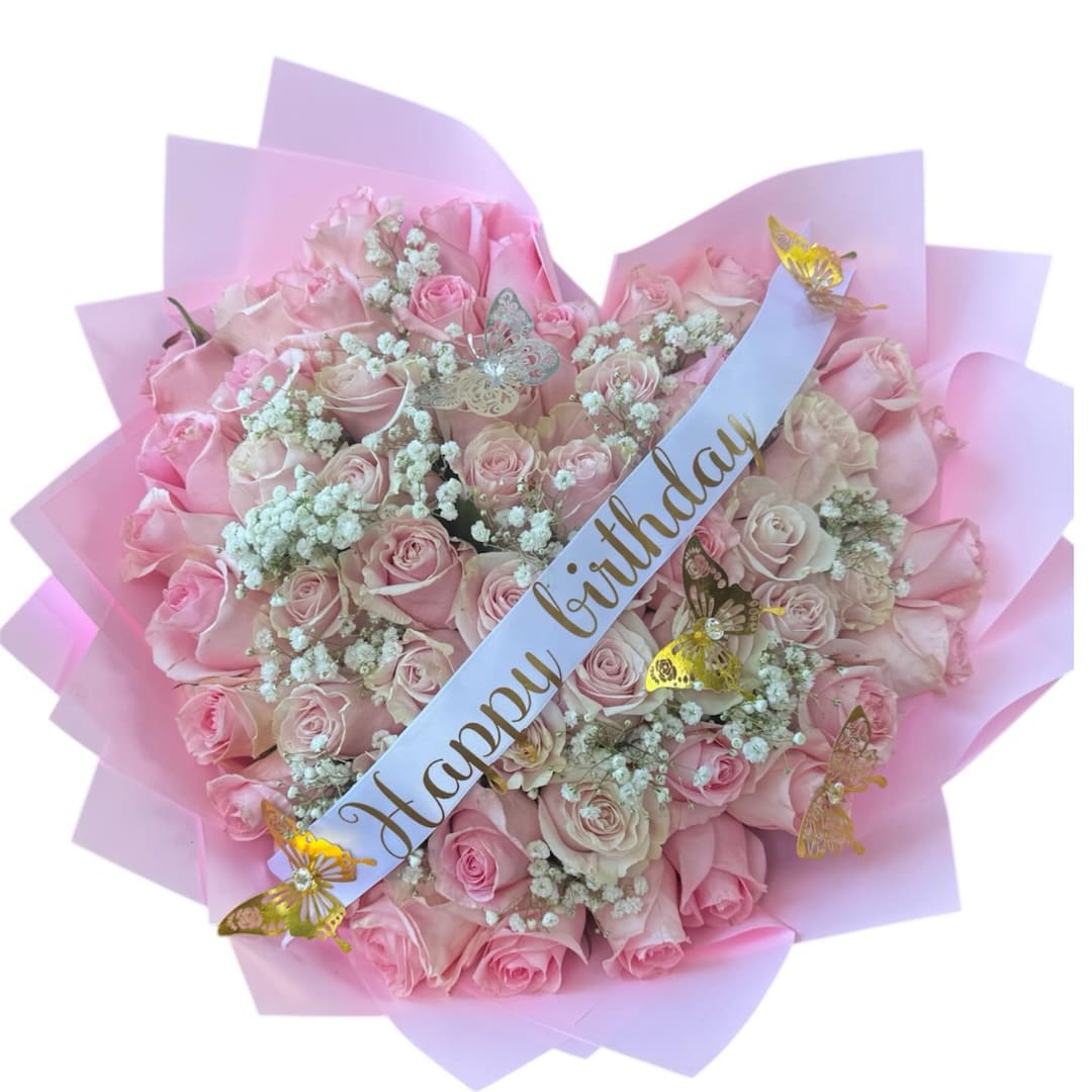 Pink rose bouquet with a birthday ribbon and butterfly decorations