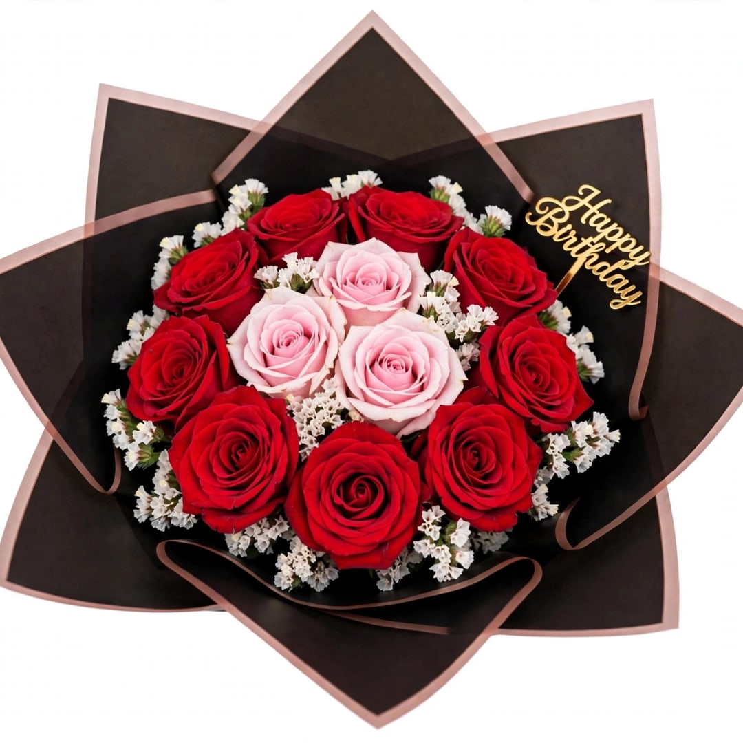 Bouquet of red and pink roses wrapped in black paper with a birthday topper