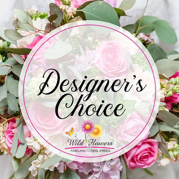 Pink roses and mixed flowers with eucalyptus around a Designer's Choice sign