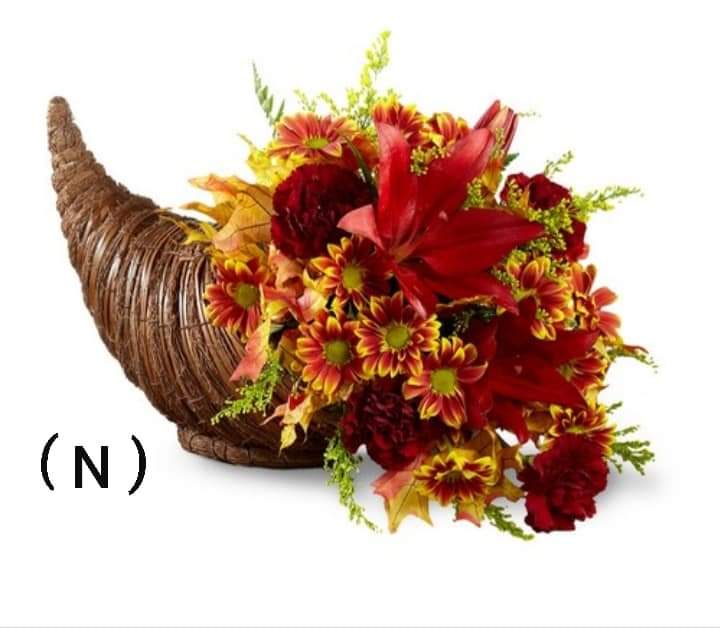 Cornucopia arrangement of red and yellow flowers in a woven horn basket