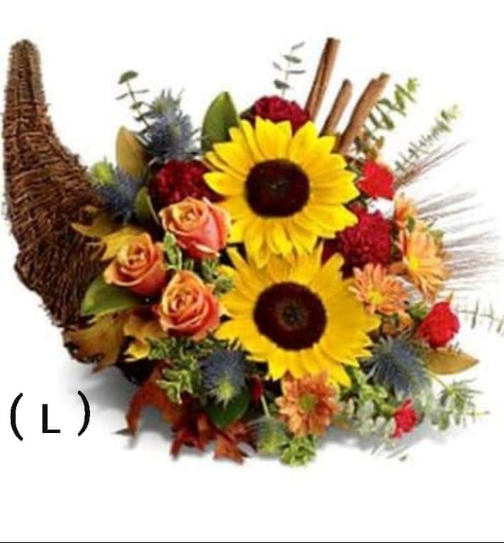 Autumn bouquet with sunflowers, roses, and a woven horn-shaped basket