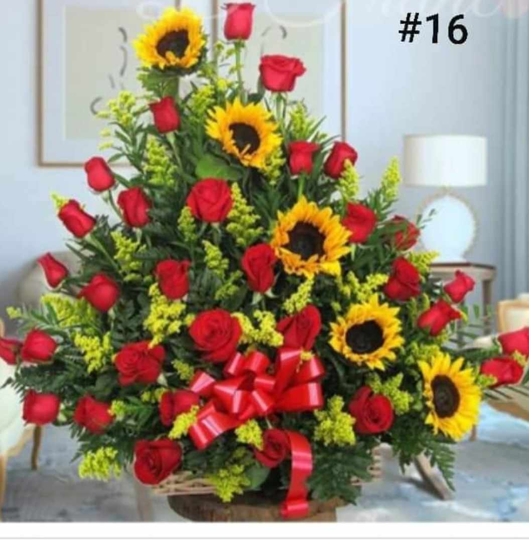 Large arrangement of red roses and sunflowers with a red ribbon bow
