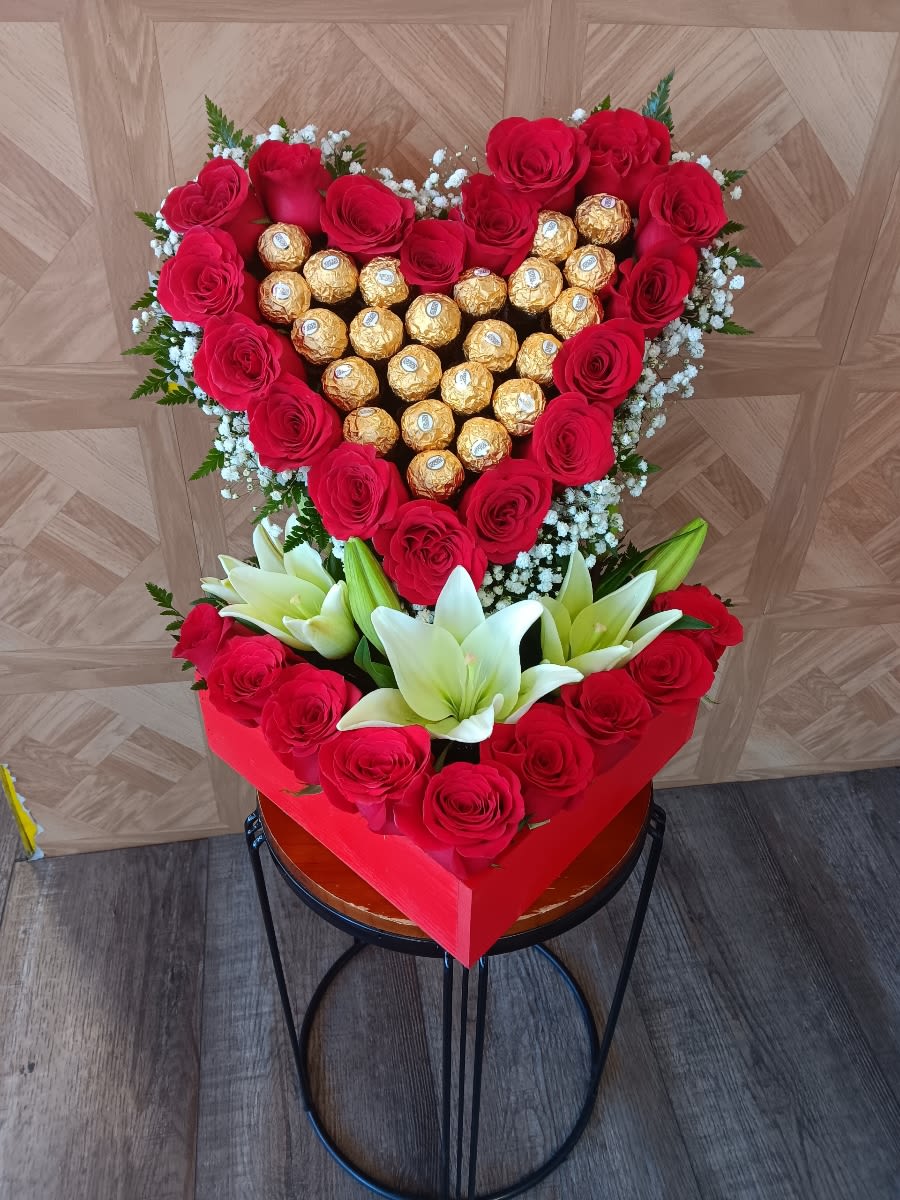 Heart-shaped rose and chocolate arrangement with white lilies