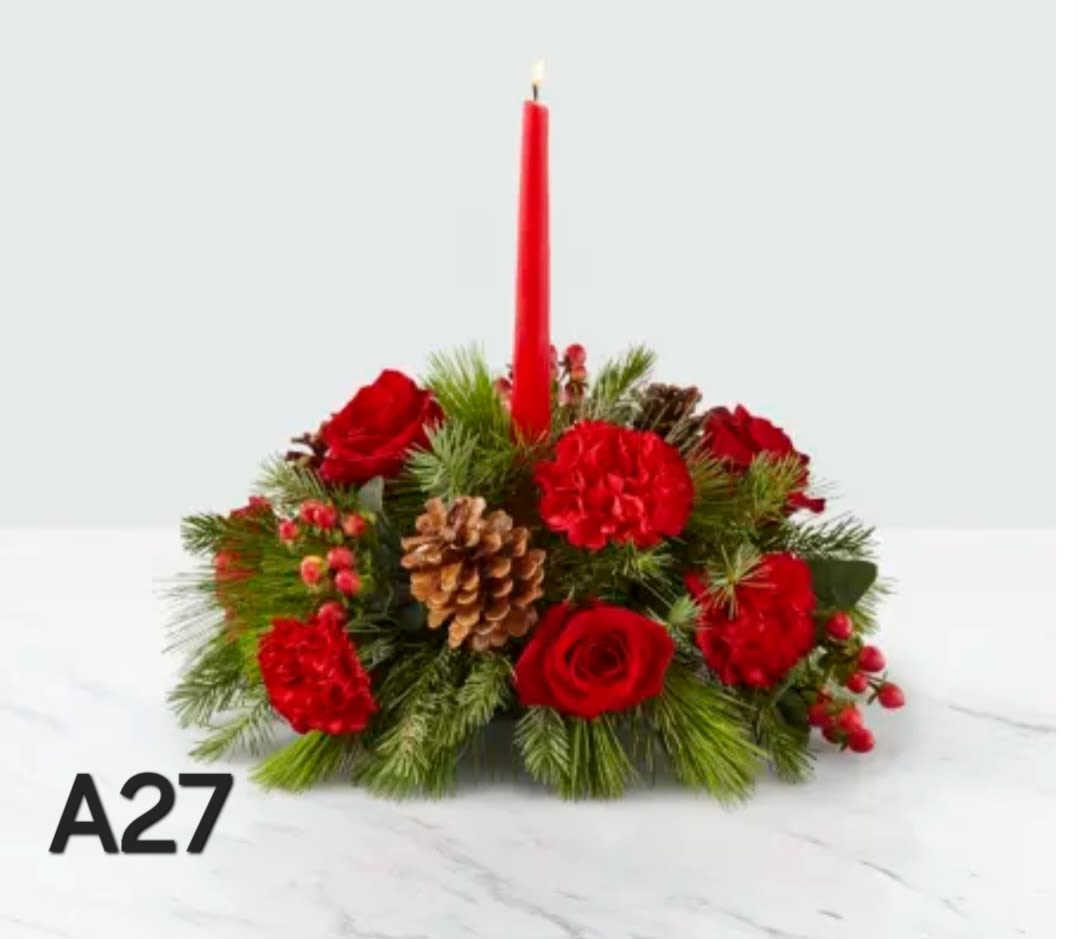 Red floral centerpiece with a tall red candle and pinecones