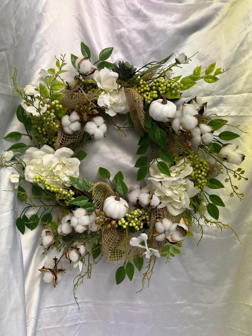 Cotton and white floral wreath with green berries and leaves