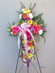 Standing floral spray with pink roses and multicolored daisies on an easel