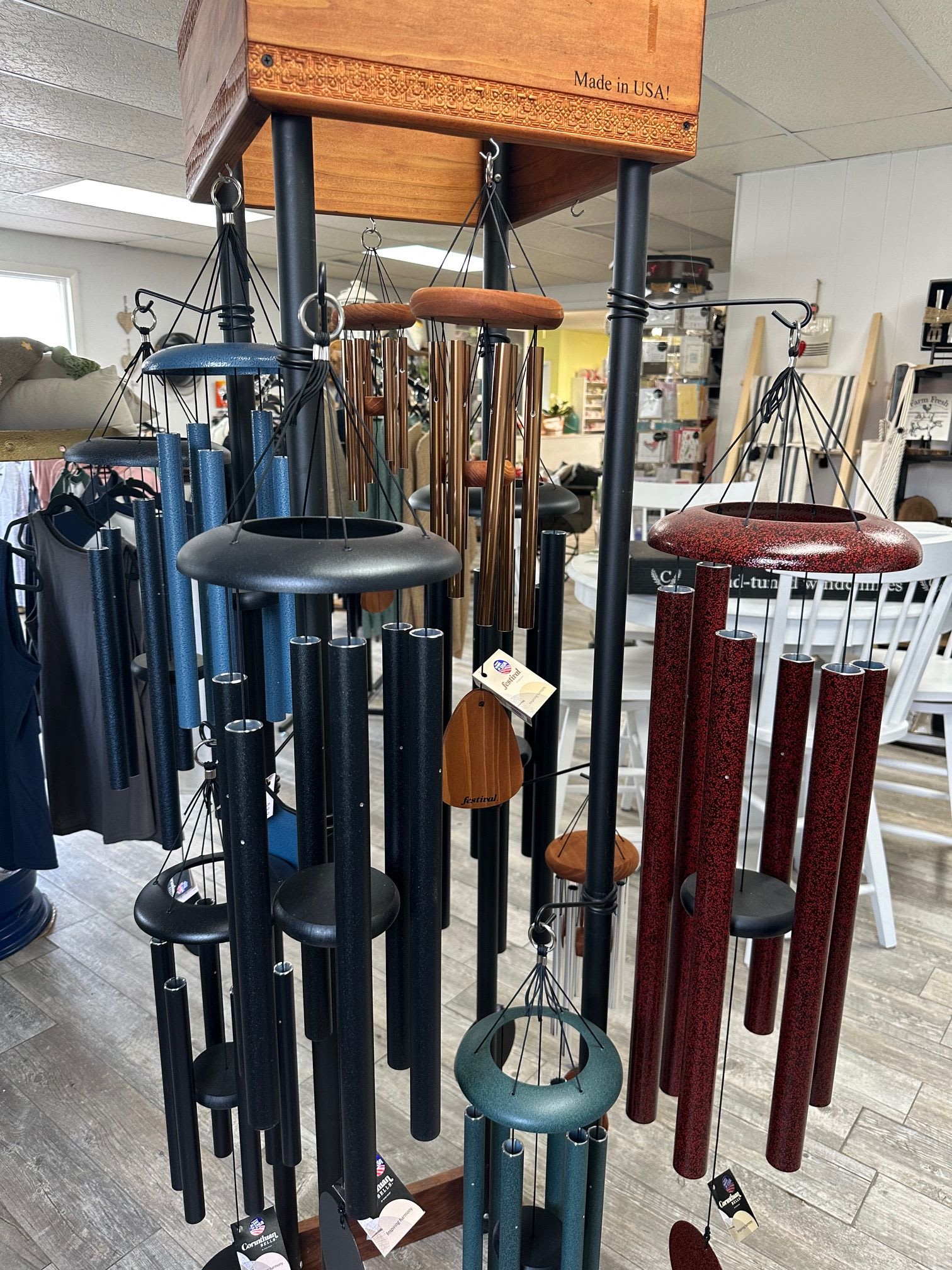 Hanging metal wind chimes in blue, black, and red finishes