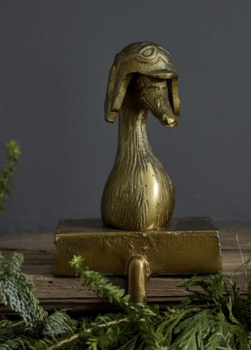 Stocking Holder Charlie - Add a playful, whimsical touch to your space with Charlie the Goose, a delightful bag holder that brings character and charm to any room. Designed with intricate detail and a fun-loving spirit, Charlie is ready to hold your stocking or ornaments with style and stability. Crafted from durable materials with a sturdy base, this charming goose will stand proud and reliable, making it a perfect addition to your home or a unique gift for loved ones. Bring a bit of fun and personality to your decor with Charlie the Goose—an accent piece that’s sure to stand out!
