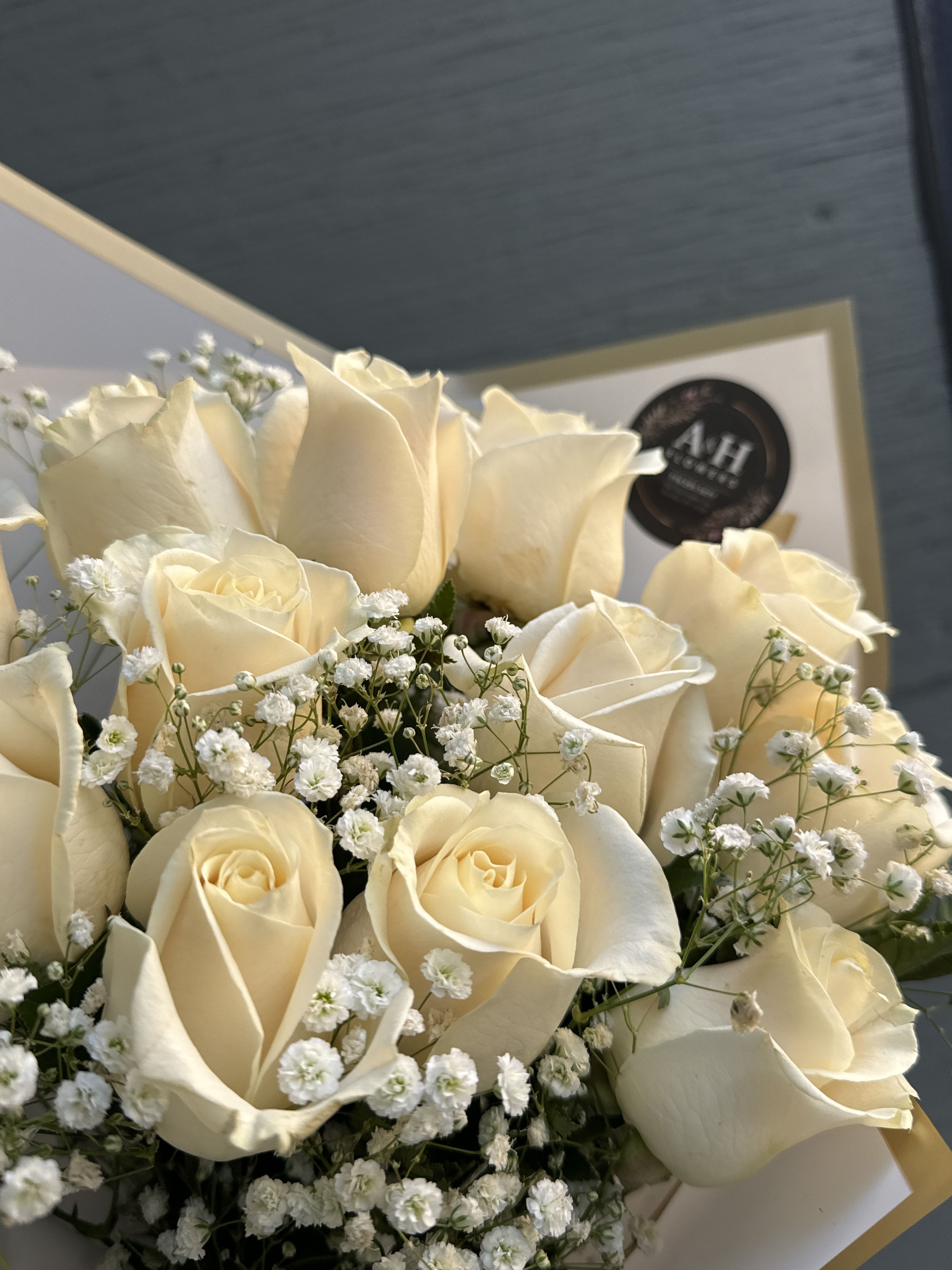 Bouquet of cream roses with small white filler flowers