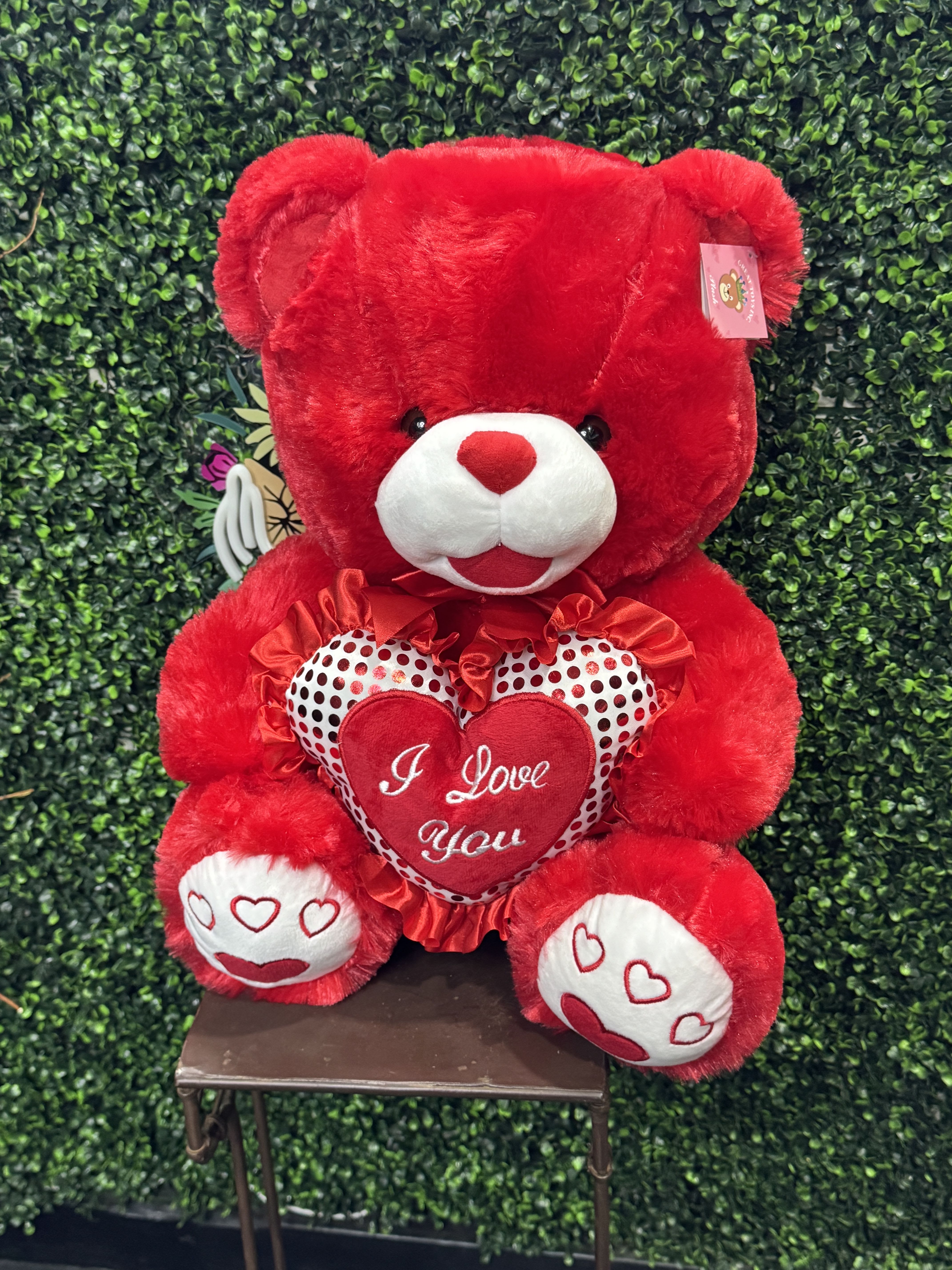 Red teddy bear holding a heart with "I Love You" text