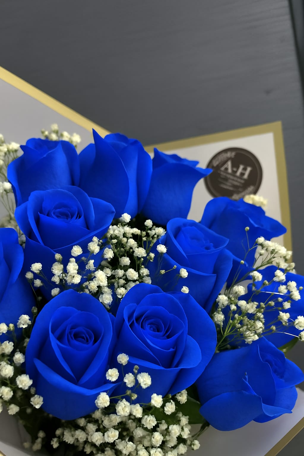 Bouquet of vivid blue roses with white baby's breath