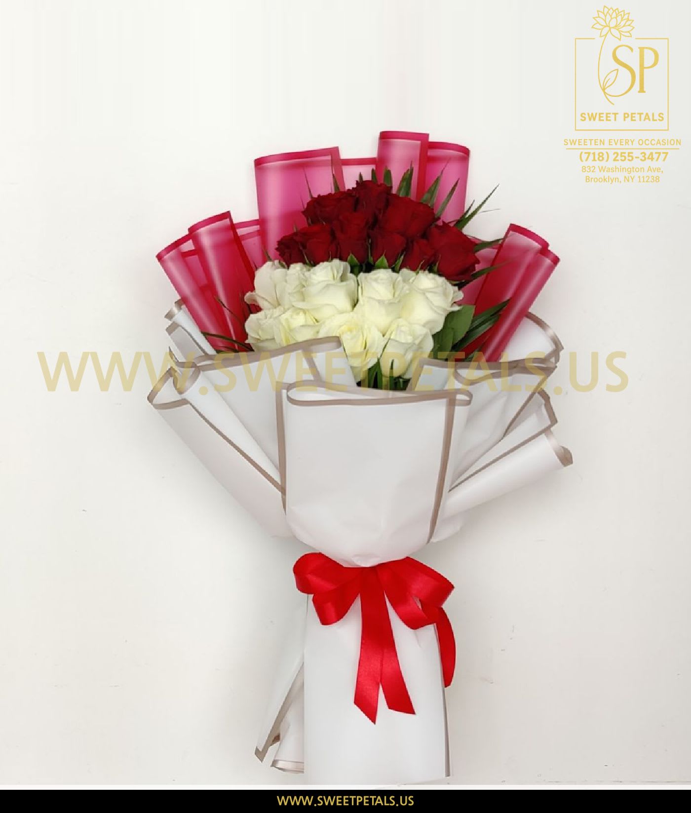 Bouquet of red and white roses wrapped in white paper with a red ribbon