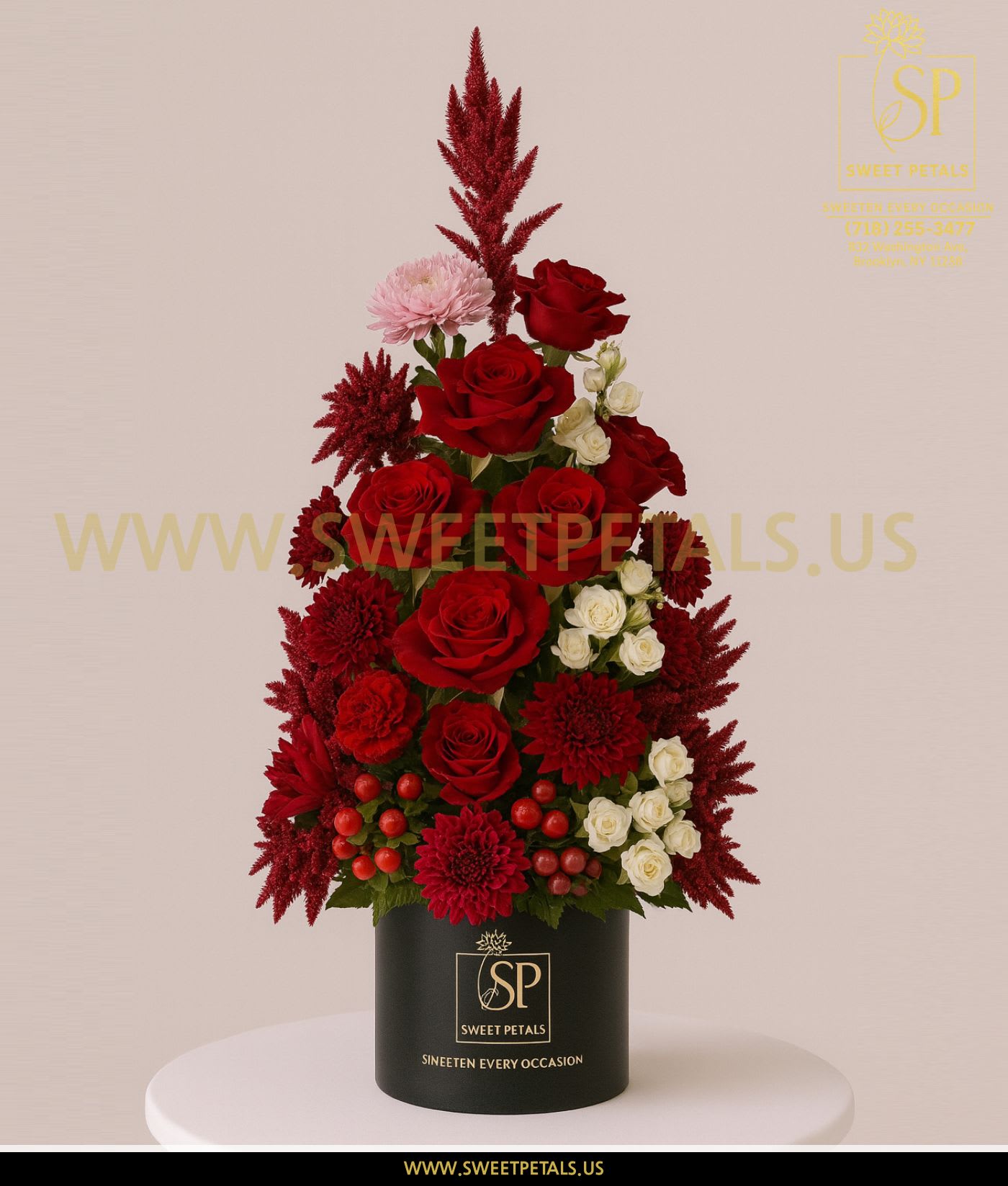 Red roses and white spray roses arranged in a black box