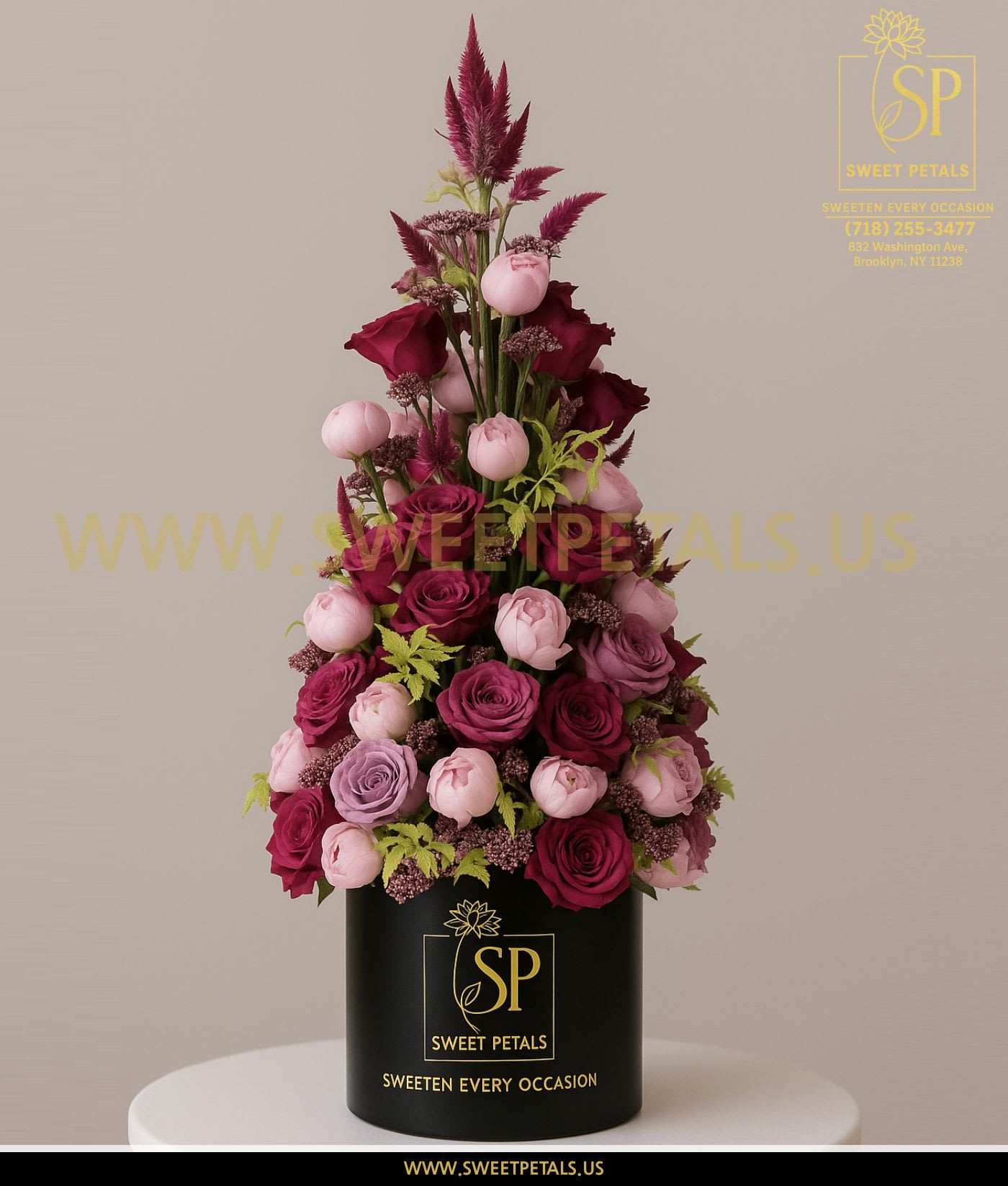 Tall arrangement of pink and burgundy roses in a black box