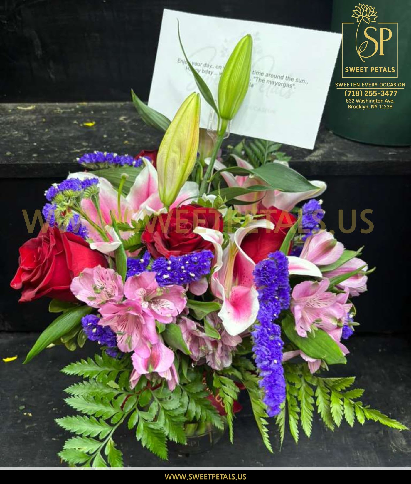 Bouquet of red roses, pink lilies, and purple filler flowers