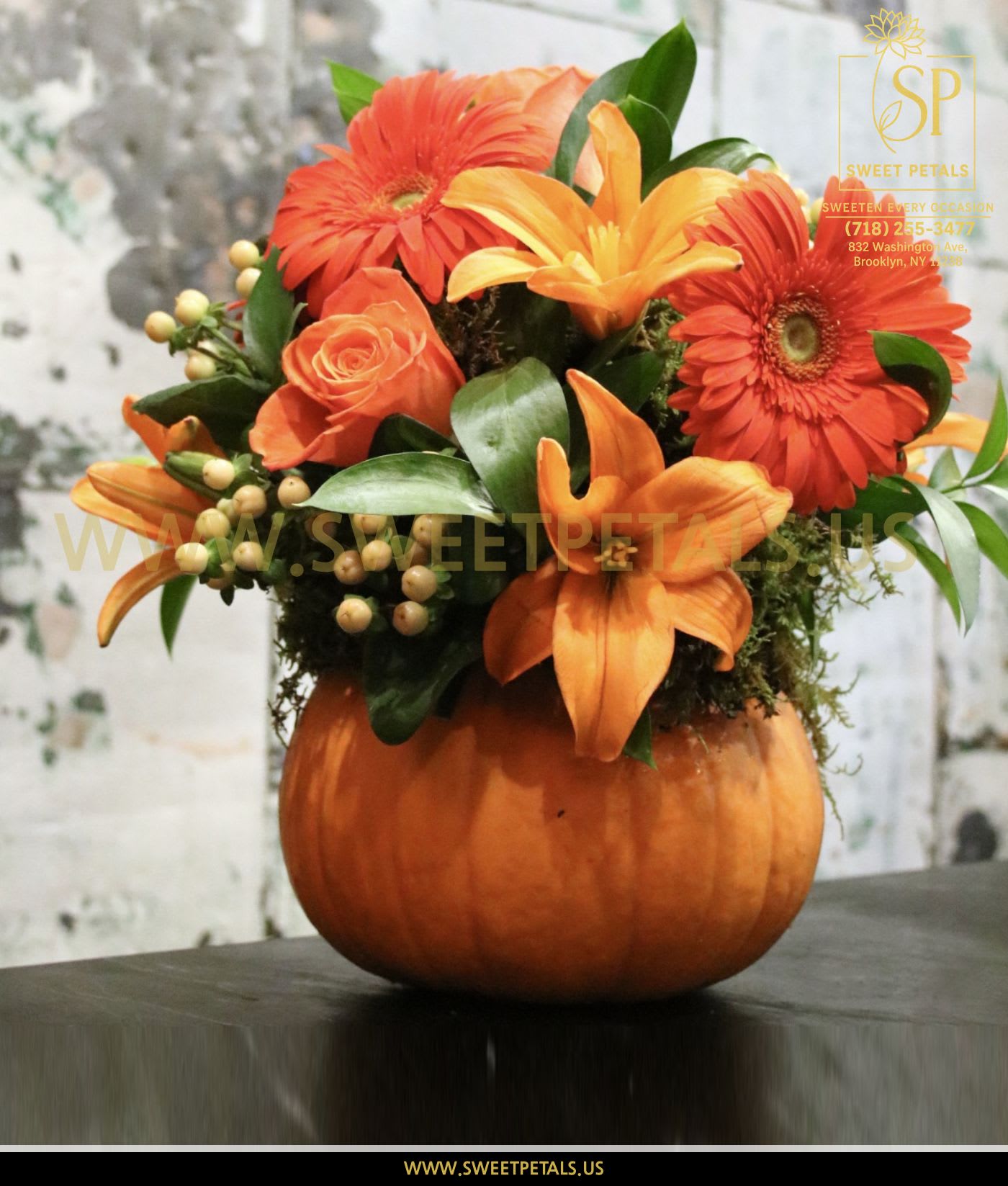 Orange floral arrangement in a pumpkin container