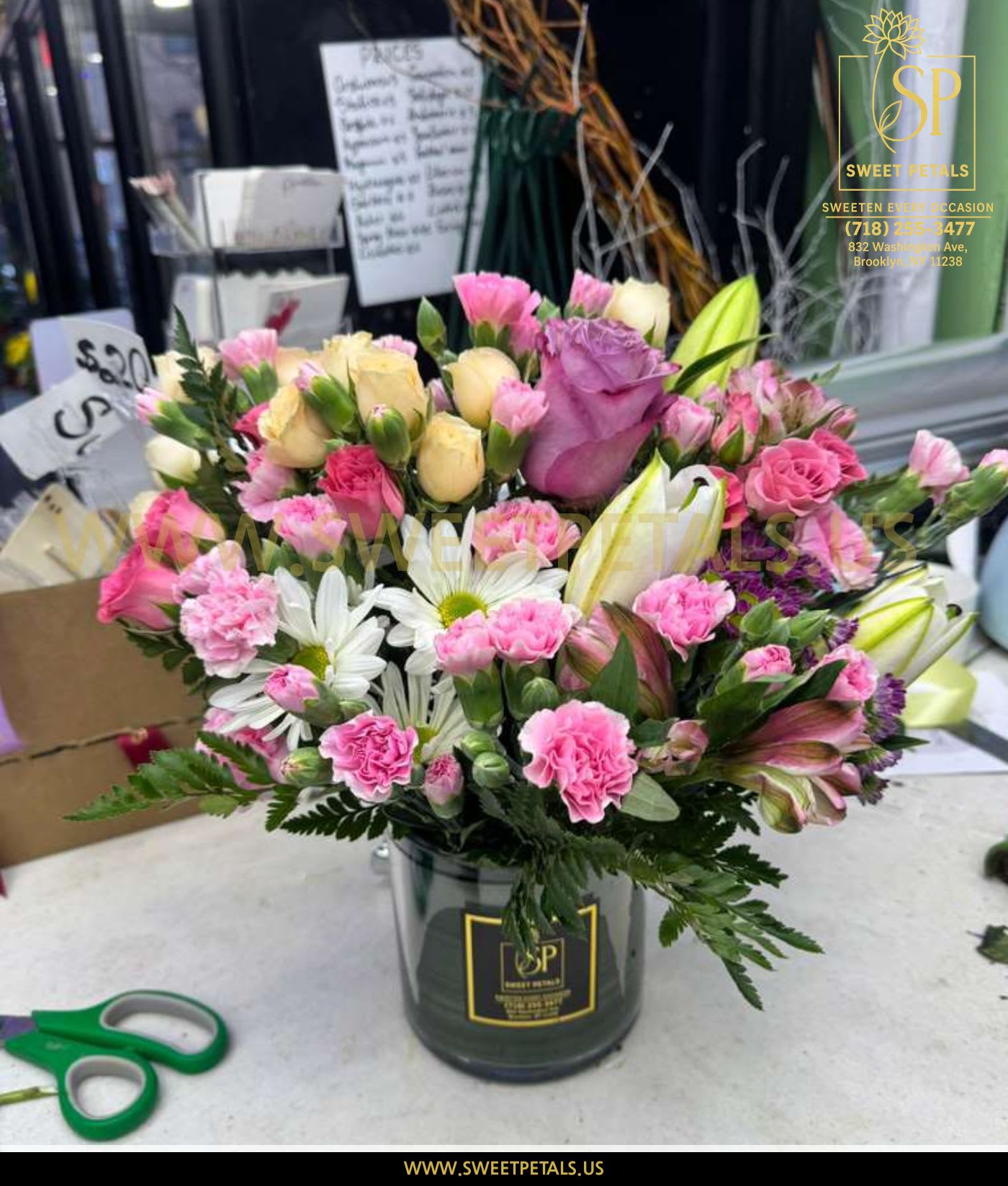Mixed pink and white bouquet in a black vase