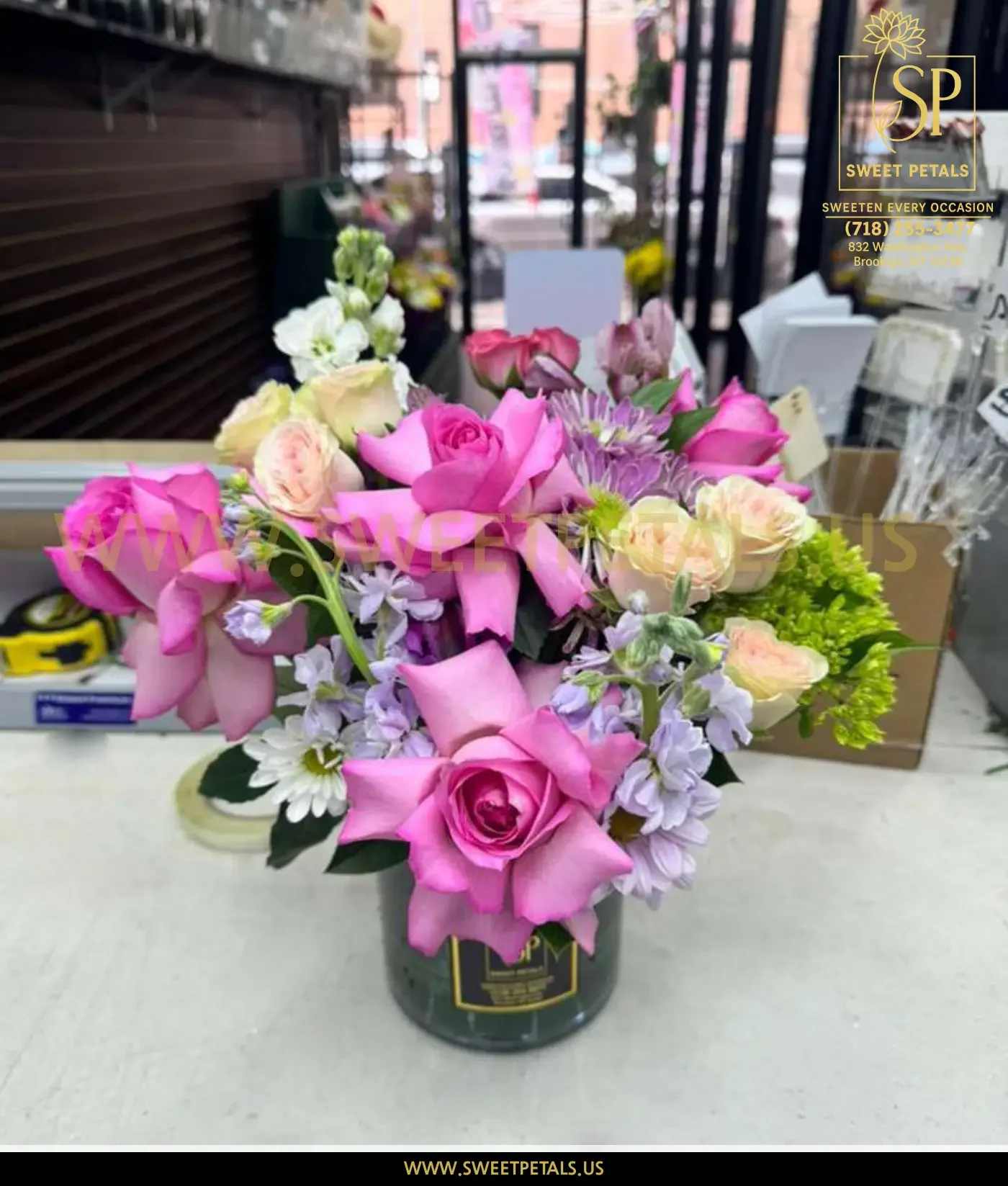 Pink and lavender rose bouquet in a dark vase