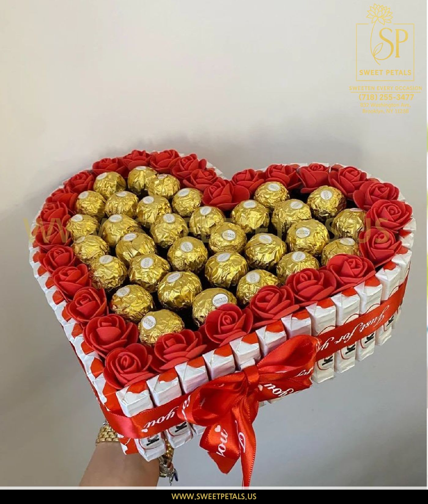 Heart-shaped gift box with red roses and gold-wrapped chocolates