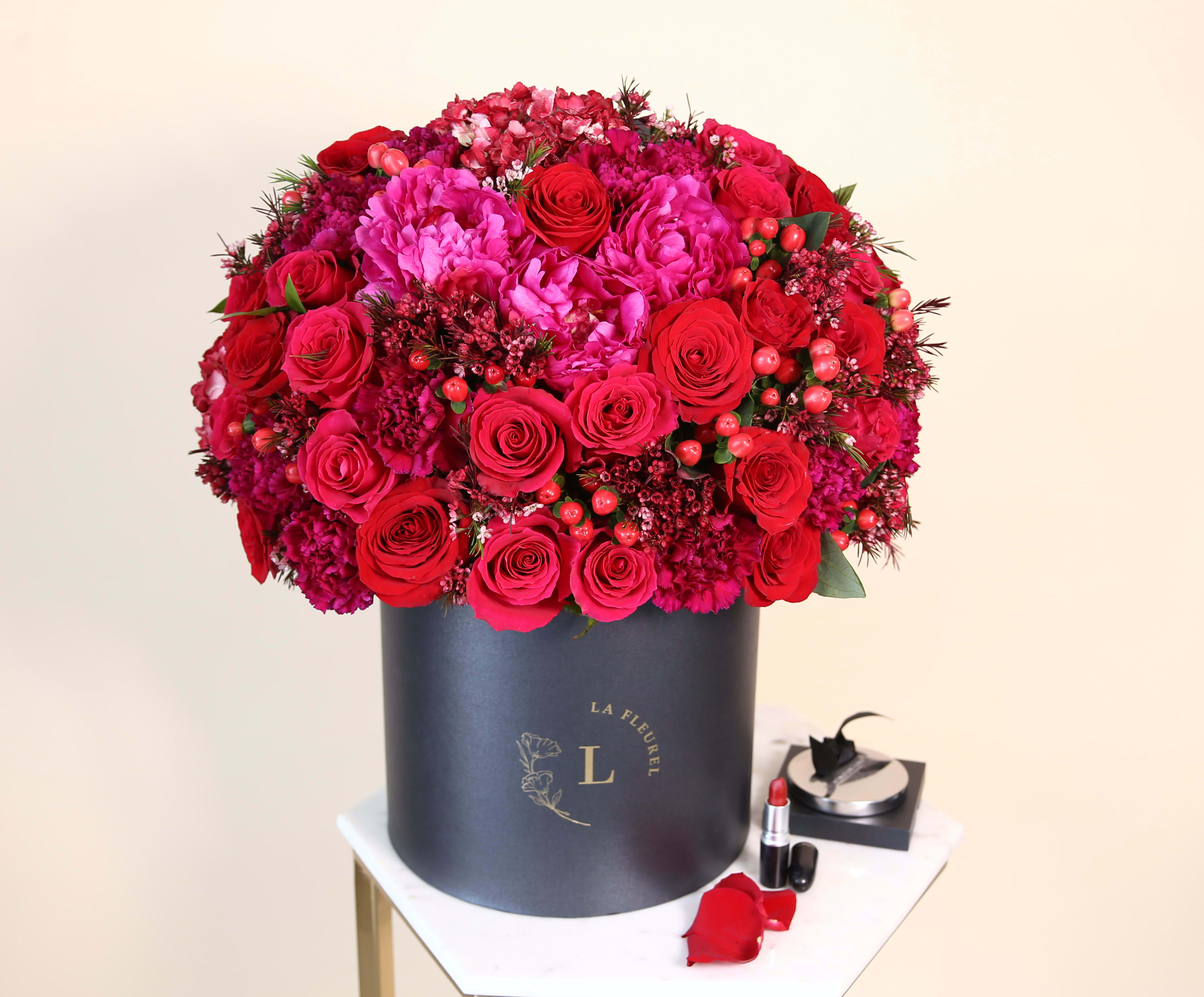 Glamour Red Arrangement - This amazing arrangement filled with the red roses,hydrangeas, greens and peonies to deliver your special message to your special someone. Perfect for any occasion.   Arrangement includes: Red roses, hydrangeas, peonies and greens Medium box measured at 9.75" Dia. x 9.25" H Custom greeting card
