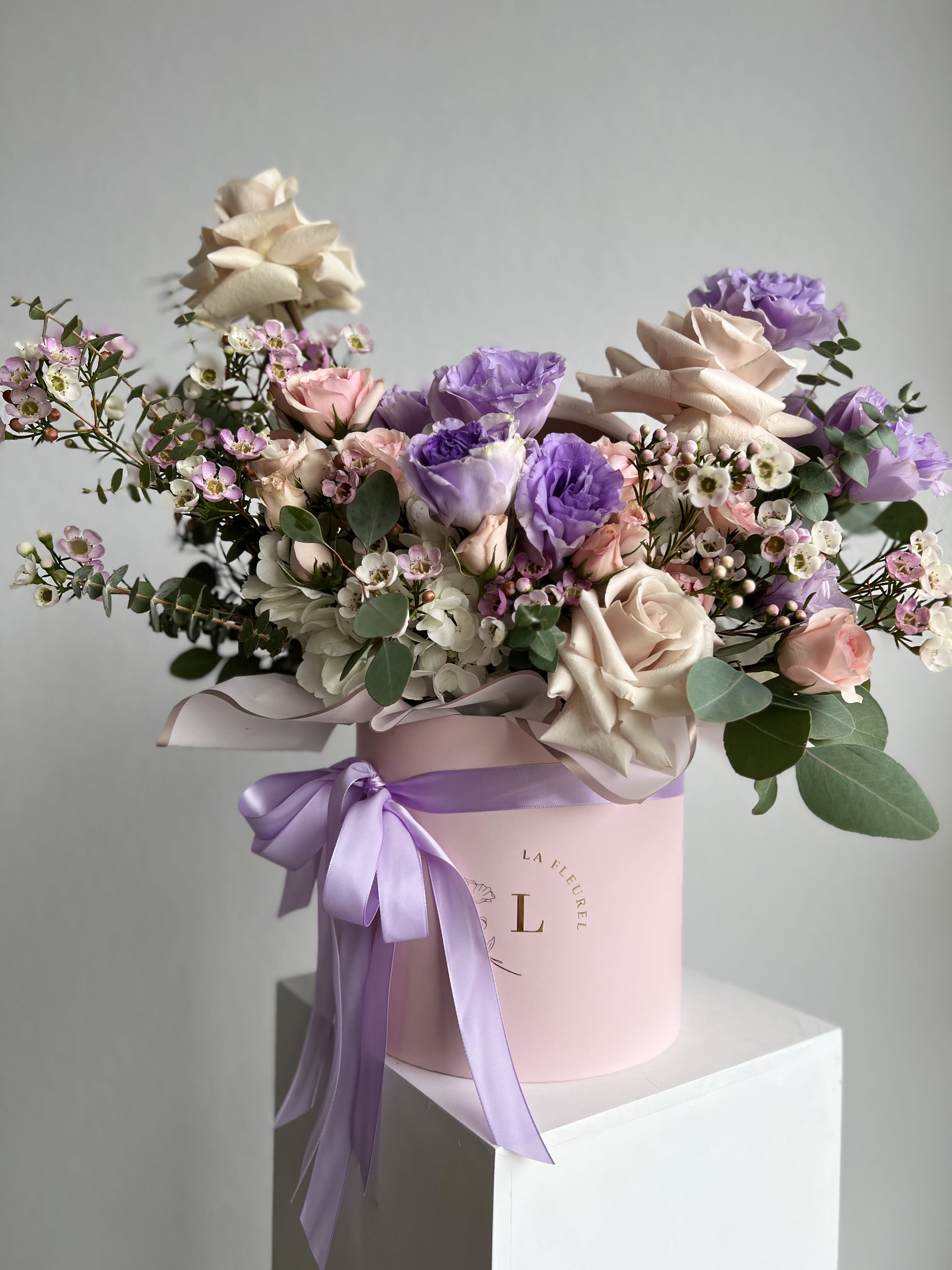 Lavender Beauty - This romantic arrangement includes roses, hydrangeas, spray roses, wax and greens.  Perfect for any occasion. You can choose any color of the box.  Arrangement includes:  SMALL BOX Custom greeting card
