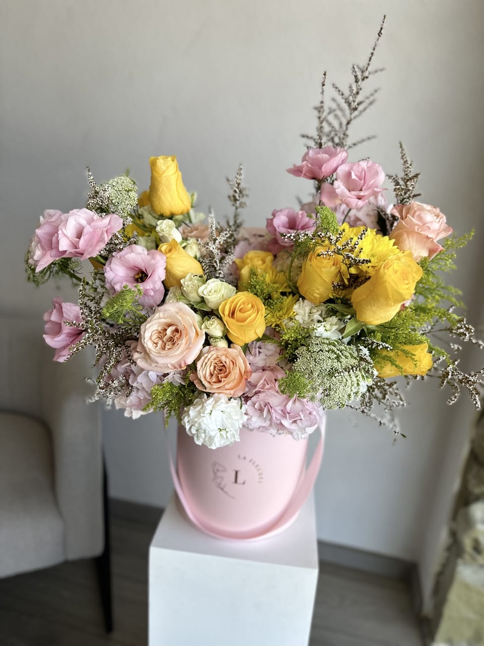 Citrus Bloom Elegance - This beautiful arrangement filled with the yellow and pink roses, hydrangeas, lisianthus and other flowers to deliver your special message to your special someone.  Perfect for any occasion. You can choose any color of the box.  Arrangement includes:  Medium box measured at 9.75" Dia. x 9.25" H Custom greeting card