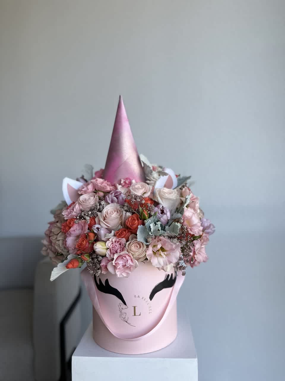 Unicorn Arrangement - This beautiful box contains a combination of fresh tulips, hydrangeas, greens and spray roses in a pink box. This floral arrangment is the perfect gift for your loved one!  Arrangement includes: Fresh roses, spray roses, hydrangeas and greens  Custom greeting card