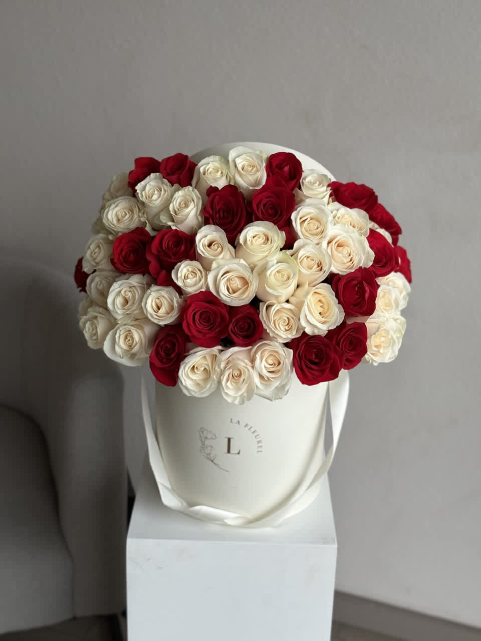 50 White and Red Roses - This beautiful arrangement filled with the white and red roses to deliver your special message to your special someone.  Perfect for any occasion. You can choose any color of the box.  Arrangement includes: roses Medium box measured at 9.75" Dia. x 9.25" H Custom greeting card