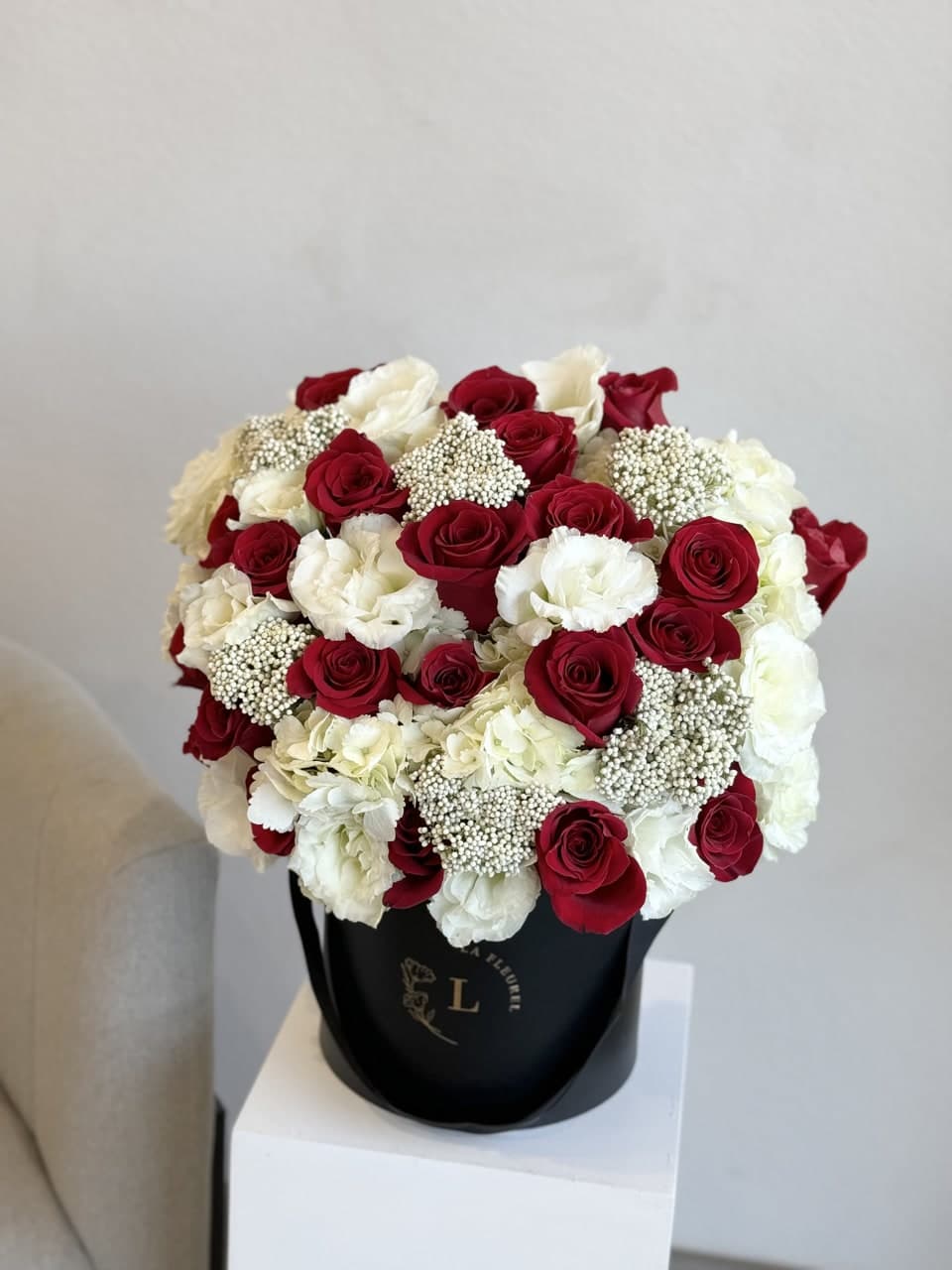 Red and White Radiance - Experience the timeless allure of our 'Red and White Radiance' bouquet. This enchanting arrangement seamlessly blends the passionate vibrancy of red blooms with the purity of white flowers, creating a striking symphony of color. Each petal exudes elegance, making it a perfect expression of love and sophistication. Bring warmth and grace to any occasion with this radiant floral masterpiece.