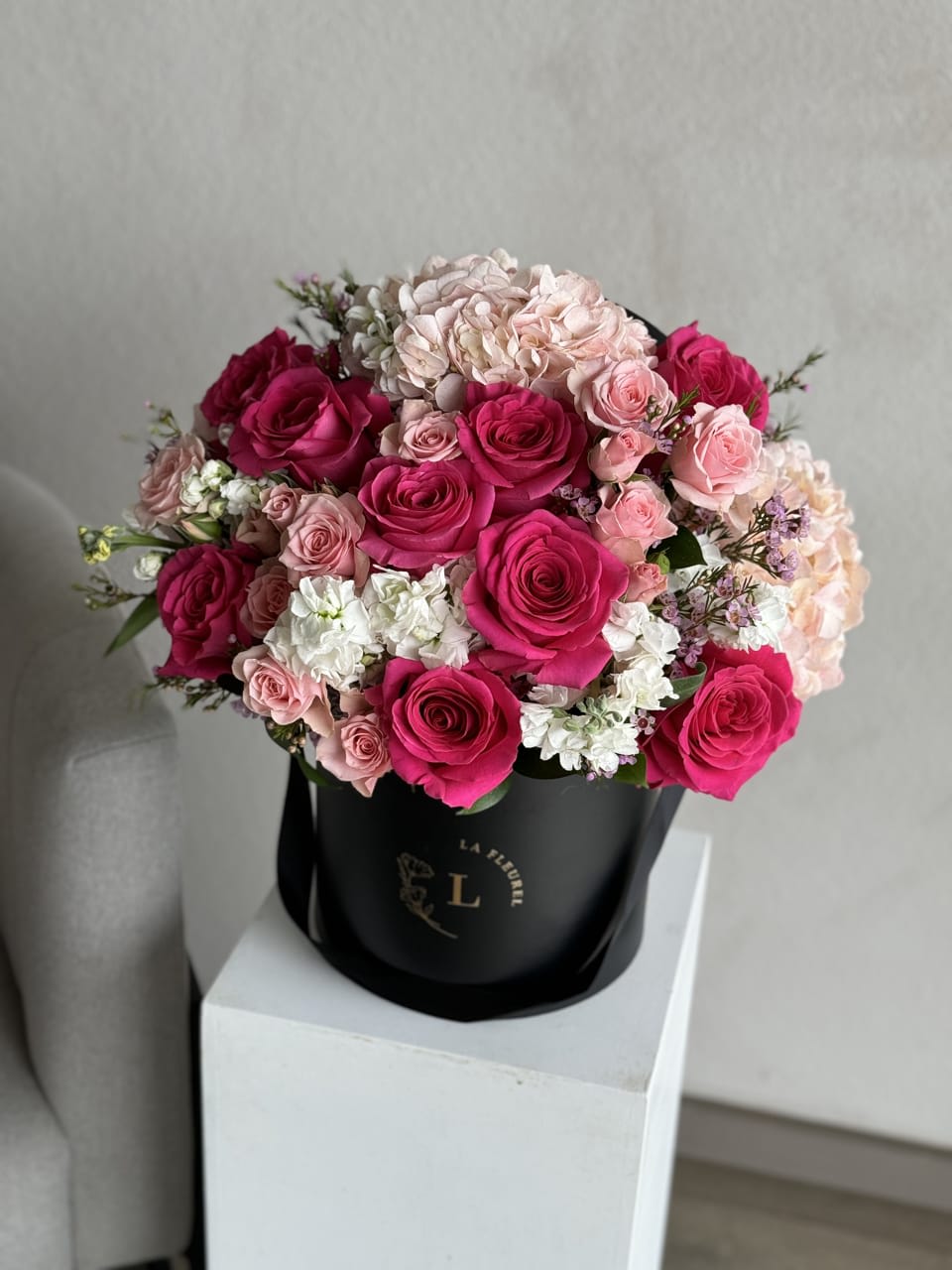 Hot Pink Rose Elegance Box - Indulge in the vibrant allure of our Hot Pink Rose Elegance Box. Each delicate bloom bursts forth with fiery passion, elegantly nestled within a chic container, creating a captivating display of beauty and sophistication. Perfect for adding a touch of vibrant charm to any space, this arrangement is a true testament to timeless elegance."
