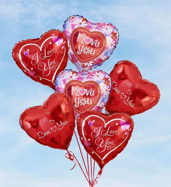 Cluster of heart-shaped red and pink balloons with love messages