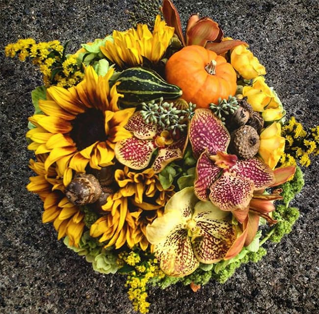 Yellow Orange Centerpiece With Exotic Orchids And Acorns By Garage Flowers