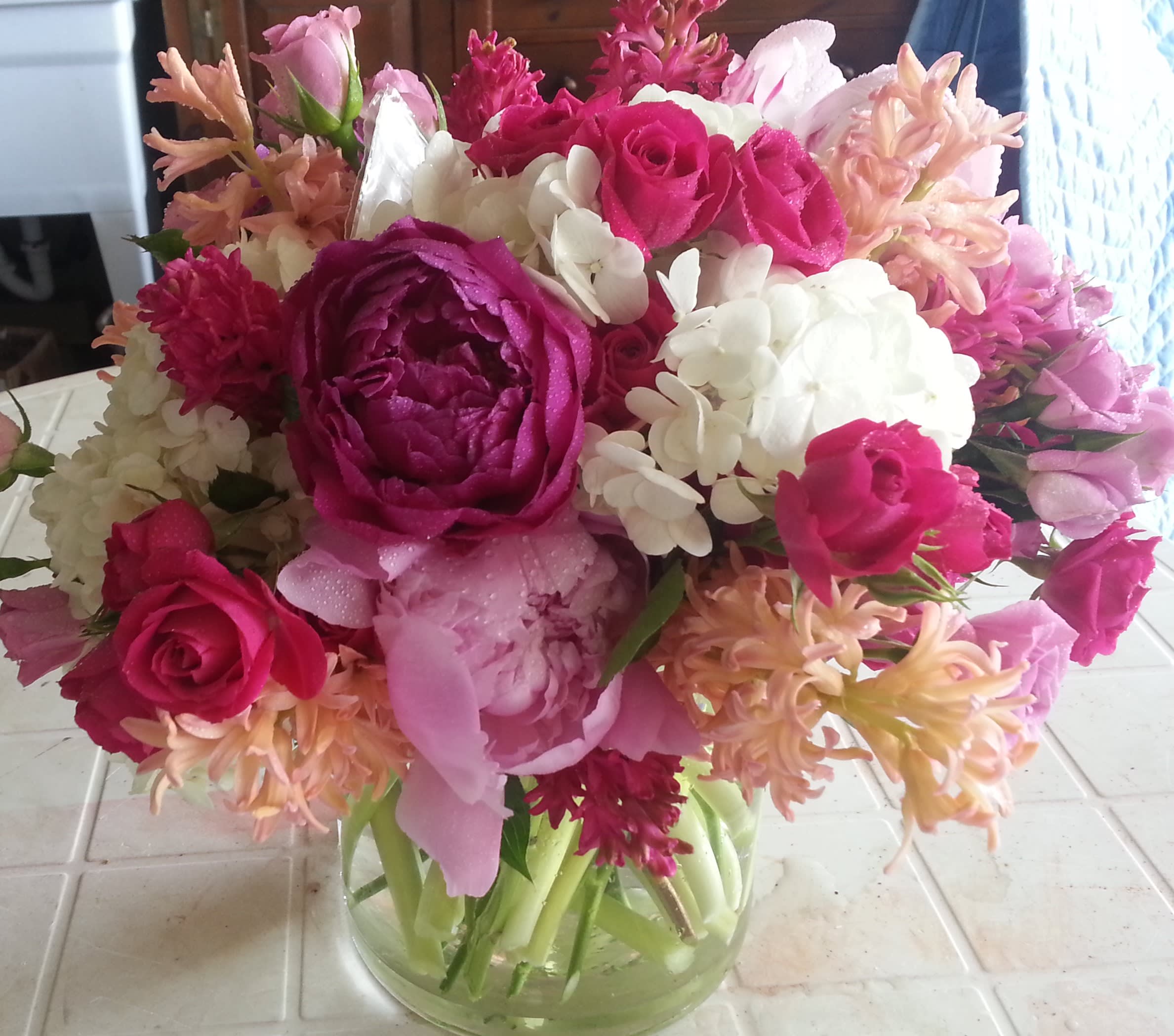 Spring Fling II Spring Fling II - peonies, hydrangeas, roses, hyacinths designed into clear glass cylinder vase.