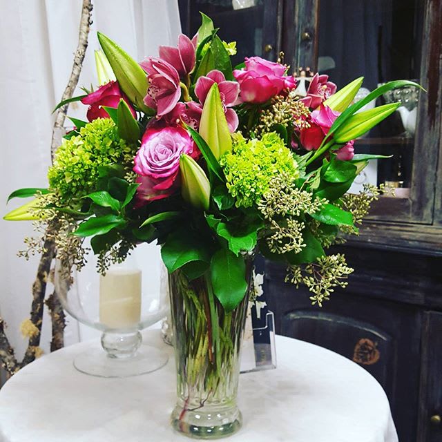 Elegant, Fun, and Flirty - Hot and pink and green has never looked better. Fluffy green hydrangea and elegant hot pink roses says everything you need in this unique and stylish arrangement. 