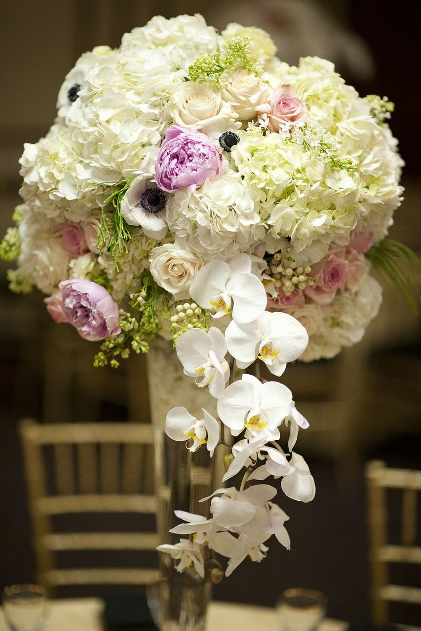 Thematic Centerpiece - A lovely mix of flowers arranged on different elegant containers depending on the occasion. The arrangement in the photo was made for a Great Gatsby event. 