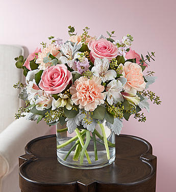 Blushing Blooms Blushing Blooms - You’ll have them at first blush when they see this stunning bouquet. We’ve gathered a lush mix of blooms in soft shades of pink, peach and white for everyday elegance. Artistically designed in a stylish clear glass cylinder vase, it’s a heartfelt gift for birthdays, anniversaries or just to tickle someone pink