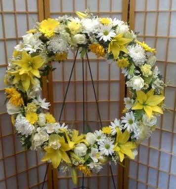 Warm Thoughts Wreath - 24&quot; wreath adorned with yellow Asiatic lilies, white roses, Daisies, Sunflowers, carnations and mums