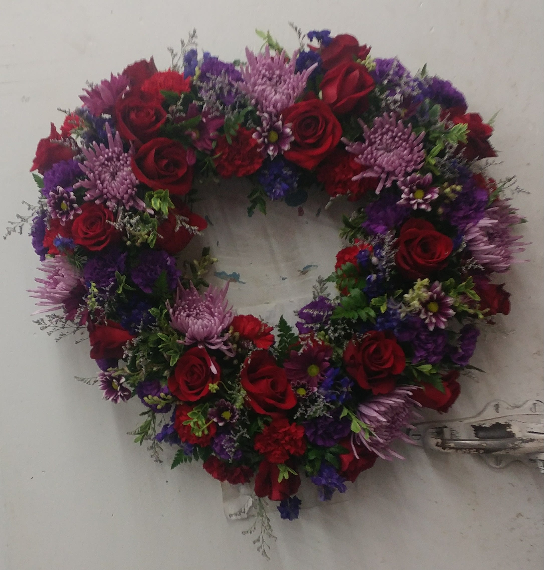 Heart tribute Heart tribute - They will always hold a special place in your heart. This sentiment is best captured with our standing, open heart-shaped arrangement in Red roses purple mums daisies and greens make this stunning heart. stands on an easle