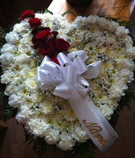 Loving Heart Loving Heart - 36" Solid Heart filled with Fresh White Flowers and a cascade of red roses and mini-carnations. *Slight Substitutions may be made, but we always fill your order to value and maintain the integrity of the arrangement.